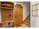Inviting entryway with custom wood storage and stairway access at 5800 Elk View Ct, Larkspur, CO 80118