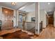 Elegant entryway featuring hardwood floors, a striking staircase, and custom woodwork at 5800 Elk View Ct, Larkspur, CO 80118