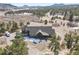 An exterior angle highlighting the home's architectural features and serene, natural surroundings at 5800 Elk View Ct, Larkspur, CO 80118