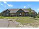 Spacious home showcasing a lush green lawn and inviting stone walkway to the front door at 5800 Elk View Ct, Larkspur, CO 80118