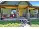 Inviting front porch featuring stone columns, a wooden porch swing and rocking chairs at 5800 Elk View Ct, Larkspur, CO 80118