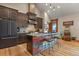 Bright kitchen featuring a custom island, granite countertops and wood cabinets at 5800 Elk View Ct, Larkspur, CO 80118