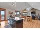Kitchen with a center island open to the dining area and Gathering room with fireplace at 5800 Elk View Ct, Larkspur, CO 80118