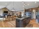 Kitchen with a large island, stainless steel appliances, open to the dining and living spaces at 5800 Elk View Ct, Larkspur, CO 80118