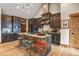 A kitchen featuring a rustic island with seating and custom cabinetry for ample storage at 5800 Elk View Ct, Larkspur, CO 80118
