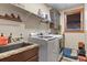 Functional laundry room featuring modern washer and dryer, granite countertop, and ample storage at 5800 Elk View Ct, Larkspur, CO 80118