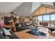 Open-concept living room with vaulted ceilings and hardwood floors connects to the kitchen at 5800 Elk View Ct, Larkspur, CO 80118