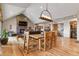 Open-concept space seamlessly connects the dining area to the living room with fireplace at 5800 Elk View Ct, Larkspur, CO 80118