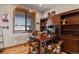 Home office with wood built-ins, a large desk, hardwood floors, and natural light at 5800 Elk View Ct, Larkspur, CO 80118