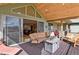 Covered patio features a cozy seating area and an outdoor fireplace with views at 5800 Elk View Ct, Larkspur, CO 80118