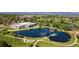 Stunning aerial view of lake with bridge, golf course, and modern community center against mountain backdrop at 9598 Lowell Blvd, Westminster, CO 80031