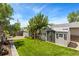 Grassy backyard featuring a shed and mature trees, creating a private and inviting outdoor space at 9598 Lowell Blvd, Westminster, CO 80031