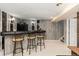 Finished basement bar area with seating, a refrigerator, and decorative wood paneling at 9598 Lowell Blvd, Westminster, CO 80031