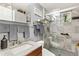 Updated bathroom with granite countertop, tiled shower with glass doors, and modern fixtures at 9598 Lowell Blvd, Westminster, CO 80031