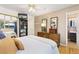 Bedroom featuring hardwood floors, closet, and a dresser with mirror at 9598 Lowell Blvd, Westminster, CO 80031