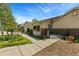 Inviting home featuring brick accents, manicured landscaping, a paved walkway, and charming front porch at 9598 Lowell Blvd, Westminster, CO 80031