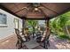 Cozy gazebo featuring a ceiling fan, comfortable seating around a table, and decorative accents for outdoor gatherings at 9598 Lowell Blvd, Westminster, CO 80031