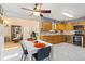 Eat-in kitchen with stainless steel appliances, wood cabinetry, and marble tile flooring at 9598 Lowell Blvd, Westminster, CO 80031