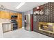 Kitchen with stainless steel appliances, a brick fireplace, and tiled floors at 9598 Lowell Blvd, Westminster, CO 80031