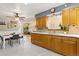 Bright eat-in kitchen with wood cabinets, marble countertops, and stainless steel appliances at 9598 Lowell Blvd, Westminster, CO 80031