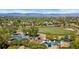 Community playground with modern blue equipment nestled amidst lush trees and neighborhood scenery at 9598 Lowell Blvd, Westminster, CO 80031