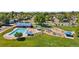 Community pool and playground with blue shades and equipment in a well-maintained green neighborhood at 9598 Lowell Blvd, Westminster, CO 80031