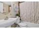 Functional bathroom featuring a tub with shower, toilet and sink with modern fixtures at 909 N Logan St # 1B, Denver, CO 80203