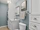 Modern powder room with a vanity, stylish mirror, and convenient washer and dryer at 909 N Logan St # 1B, Denver, CO 80203