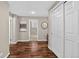 Hallway with hardwood floors and neutral walls leading to an open bedroom and a closet at 909 N Logan St # 1B, Denver, CO 80203