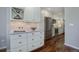 Stylish kitchen boasts stainless steel appliances, white cabinets, and a tiled backsplash for a modern look at 909 N Logan St # 1B, Denver, CO 80203
