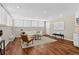 Bright living room featuring hardwood floors, recessed lighting, a white couch, and a decorative area rug at 909 N Logan St # 1B, Denver, CO 80203