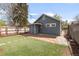 Charming backyard with new turf, stone patio, and string lights, creating a relaxing outdoor retreat at 4933 Grove St, Denver, CO 80221