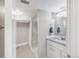 Bright bathroom with updated vanity, granite countertop, framed mirror, and glass shower at 4933 Grove St, Denver, CO 80221