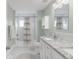 Bright bathroom with a shower-tub combination, hexagonal tile floors and granite vanity at 4933 Grove St, Denver, CO 80221