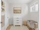 Bright Bedroom featuring a gray crib, white dresser, neutral colored walls, and natural light at 4933 Grove St, Denver, CO 80221