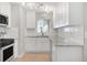 Bright kitchen featuring white cabinets, granite countertops, stainless steel appliances and subway tile backsplash at 4933 Grove St, Denver, CO 80221