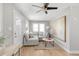 Bright living room with a gray sectional couch, modern art, and light hardwood floors at 4933 Grove St, Denver, CO 80221