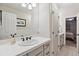Clean bathroom with a white vanity, tile backsplash, and a view to another room at 35 Brookhaven Pl, Littleton, CO 80123