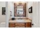 Powder room featuring a rustic mirror and decorative tile accents at 35 Brookhaven Pl, Littleton, CO 80123