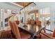 Spacious dining room featuring a long wooden table, stylish chairs, and elegant lighting at 35 Brookhaven Pl, Littleton, CO 80123