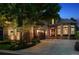 Charming home with a stone and stucco exterior, well-manicured landscaping, and an attached garage at dusk at 35 Brookhaven Pl, Littleton, CO 80123