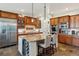 Modern kitchen with stainless steel appliances, large island with bar seating, and abundant storage at 35 Brookhaven Pl, Littleton, CO 80123