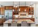 Lovely kitchen with a large center island, wood cabinetry, and stainless steel refrigerator at 35 Brookhaven Pl, Littleton, CO 80123