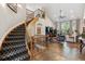 Inviting living space featuring a curved staircase and abundant natural light at 35 Brookhaven Pl, Littleton, CO 80123