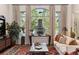 Bright living room with large windows, fireplace, and comfortable seating, creating an inviting space for relaxation and entertainment at 35 Brookhaven Pl, Littleton, CO 80123
