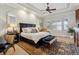 Spacious main bedroom with tray ceiling, luxurious bed, and a cozy sitting area, offering a private retreat at 35 Brookhaven Pl, Littleton, CO 80123
