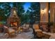 Outdoor stone fireplace and patio area with cozy seating and a grill at 35 Brookhaven Pl, Littleton, CO 80123