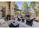 Outdoor patio with stone fireplace, pergola, and comfortable seating at 35 Brookhaven Pl, Littleton, CO 80123
