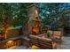 Inviting outdoor patio with stone fireplace, comfortable seating, and outdoor grill at 35 Brookhaven Pl, Littleton, CO 80123