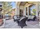 Inviting covered patio with stone flooring, outdoor seating, grill, and seamless indoor/outdoor flow at 35 Brookhaven Pl, Littleton, CO 80123